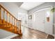Bright foyer with wood-look floors, staircase, and a white front door with sidelights welcomes you home at 1401 Cooper River Blvd, Moncks Corner, SC 29461