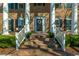 Gracious front entrance featuring brick steps, white columns, and a welcoming black front door at 1401 Cooper River Blvd, Moncks Corner, SC 29461