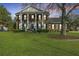 Stately two-story brick home with prominent white columns and a beautifully manicured front lawn at 1401 Cooper River Blvd, Moncks Corner, SC 29461