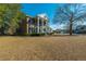 Spacious two-story brick home with white columns, showcasing its classic Southern charm and curb appeal at 1401 Cooper River Blvd, Moncks Corner, SC 29461