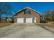 Two-car attached garage with white doors and an ample driveway, offering plenty of parking space at 1401 Cooper River Blvd, Moncks Corner, SC 29461