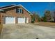 Two-car attached garage with white doors and an ample driveway, offering plenty of parking space at 1401 Cooper River Blvd, Moncks Corner, SC 29461