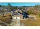 Rear aerial view of a brick home with an attached two-car garage and a spacious driveway at 1401 Cooper River Blvd, Moncks Corner, SC 29461