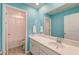 Bright bathroom with turquoise walls, a large mirror, and access to a separate toilet and shower at 146 Stagecoach Ave, Summerville, SC 29486