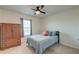 Cozy bedroom with a ceiling fan, a wooden wardrobe, and a comfortable twin bed near a bright window at 146 Stagecoach Ave, Summerville, SC 29486