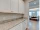 Butlers pantry boasts ample counter space, shaker cabinets, and a granite countertop at 146 Stagecoach Ave, Summerville, SC 29486