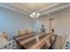 Dining room with wood table, seating and modern chandelier under tray ceiling at 146 Stagecoach Ave, Summerville, SC 29486