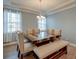 Elegant dining room with a large table, decorative chandelier, and abundant natural light at 146 Stagecoach Ave, Summerville, SC 29486