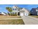Beautifully landscaped two-story home with a two-car garage and a welcoming facade at 146 Stagecoach Ave, Summerville, SC 29486
