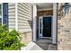 Charming entryway with a brick facade, a black front door, and decorative plants at 146 Stagecoach Ave, Summerville, SC 29486