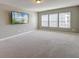 Spacious living room with plush carpeting, natural light, and a large wall-mounted television at 146 Stagecoach Ave, Summerville, SC 29486