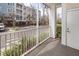 Screened balcony with a view of the parking lot, plants, and the exterior of the building at 1755 Central Park Rd # 5107, Charleston, SC 29412