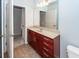 This bathroom features a dark wood vanity with granite countertop and framed mirror at 1755 Central Park Rd # 5107, Charleston, SC 29412