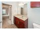 Bright bathroom features a vanity with a neutral countertop, wood cabinets, and chrome fixtures at 1755 Central Park Rd # 5107, Charleston, SC 29412