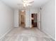 This bedroom features neutral walls, plush carpet, a ceiling fan, and has access to a full bathroom at 1755 Central Park Rd # 5107, Charleston, SC 29412
