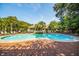 Refreshing community pool surrounded by lounge chairs and palm trees at 1755 Central Park Rd # 5107, Charleston, SC 29412