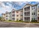 Charming apartment building with screened porches and well-maintained landscaping under a partly cloudy sky at 1755 Central Park Rd # 5107, Charleston, SC 29412