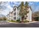 Apartment building exterior showcasing multiple screened in patios along a quiet street at 1755 Central Park Rd # 5107, Charleston, SC 29412