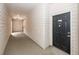 Hallway of building leading to unit with black door numbered 5107 and wood paneled walls at 1755 Central Park Rd # 5107, Charleston, SC 29412