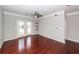 An elegant living room with hardwood floors, ceiling fan, and French doors leading to a balcony at 1755 Central Park Rd # 5107, Charleston, SC 29412