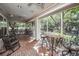 Community screened patio features views of trees, an outdoor seating arrangement, and ceiling fans at 1755 Central Park Rd # 5107, Charleston, SC 29412