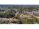 Expansive aerial view of homes and tree-filled lots, set against a partially cloudy sky at 1812 Burgess St, Charleston, SC 29412