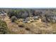 Expansive aerial view showcases multiple properties surrounded by a lush, wooded landscape under a clear sky at 1812 Burgess St, Charleston, SC 29412