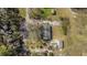 Overhead shot of a yard, home, and small shed bordered by trees and underbrush at 1812 Burgess St, Charleston, SC 29412