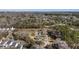Extensive aerial shot revealing residential areas amidst dense trees, with a skyline and body of water visible at 1812 Burgess St, Charleston, SC 29412