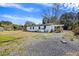 Charming single-story home with a pergola, set on a gravel lot with a partially grassy yard at 1812 Burgess St, Charleston, SC 29412