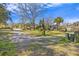 Inviting front yard with mature trees, showcasing a blend of nature and home charm at 1812 Burgess St, Charleston, SC 29412