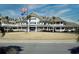 Expansive clubhouse with American and state flags displayed in front of a manicured lawn at 2017 Long Bend Dr, Seabrook Island, SC 29455