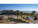 Exterior of a clubhouse surrounded by landscaped grounds, palm trees, and distant ocean view at 2017 Long Bend Dr, Seabrook Island, SC 29455