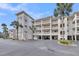 Coastal condo building with multi-level decks, palms, and covered parking at 2017 Long Bend Dr, Seabrook Island, SC 29455