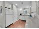 Well-lit kitchen with white cabinets, stainless appliances, and hardwood floors at 2017 Long Bend Dr, Seabrook Island, SC 29455