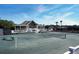 Exterior of tennis court with clubhouse, white railings, and lush green surroundings, clear sky at 2017 Long Bend Dr, Seabrook Island, SC 29455