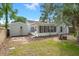 Backyard showcasing the home's exterior with a sunroom, a brick patio, and mature trees at 204 Tram Blvd, Summerville, SC 29486