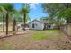 Landscaped backyard of the home with a patio area and surrounded by palm trees and a wooden fence at 204 Tram Blvd, Summerville, SC 29486
