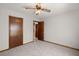 Carpeted bedroom with a ceiling fan, neutral walls, and two wood doors at 204 Tram Blvd, Summerville, SC 29486