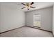 Carpeted bedroom featuring a ceiling fan, window, and neutral walls at 204 Tram Blvd, Summerville, SC 29486