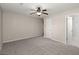 Carpeted bedroom with a ceiling fan and two doors, one leading to bathroom at 204 Tram Blvd, Summerville, SC 29486