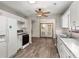 View of the kitchen with white cabinets and a wood-look floor leading to French doors at 204 Tram Blvd, Summerville, SC 29486