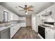 Well-lit kitchen with white cabinets, stainless steel dishwasher, and wood-look flooring at 204 Tram Blvd, Summerville, SC 29486