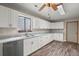 Bright kitchen with white cabinets, grey countertops, stainless steel dishwasher and wood-look flooring at 204 Tram Blvd, Summerville, SC 29486