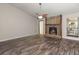 Cozy living room with a stone fireplace and hardwood floors at 204 Tram Blvd, Summerville, SC 29486