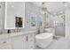 Bright bathroom showcasing double vanities, soaking tub, glass shower, and ample natural light at 213 Amberjack Ln, Charleston, SC 29492