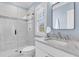 Modern bathroom with glass-enclosed shower, marble countertop vanity, and light blue walls at 213 Amberjack Ln, Charleston, SC 29492