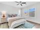 Bright bedroom featuring a queen bed, nightstand, area rug and large windows at 213 Amberjack Ln, Charleston, SC 29492