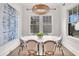 Bright dining room with modern chandelier, shiplap walls, and a table for six at 213 Amberjack Ln, Charleston, SC 29492