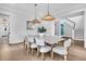 Chic dining area features elegant lighting, modern table with seating for eight at 213 Amberjack Ln, Charleston, SC 29492